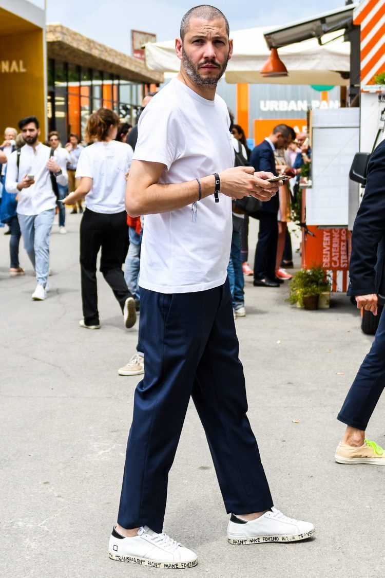Simple white T-shirt and navy pants coordinate accented with sneaker design