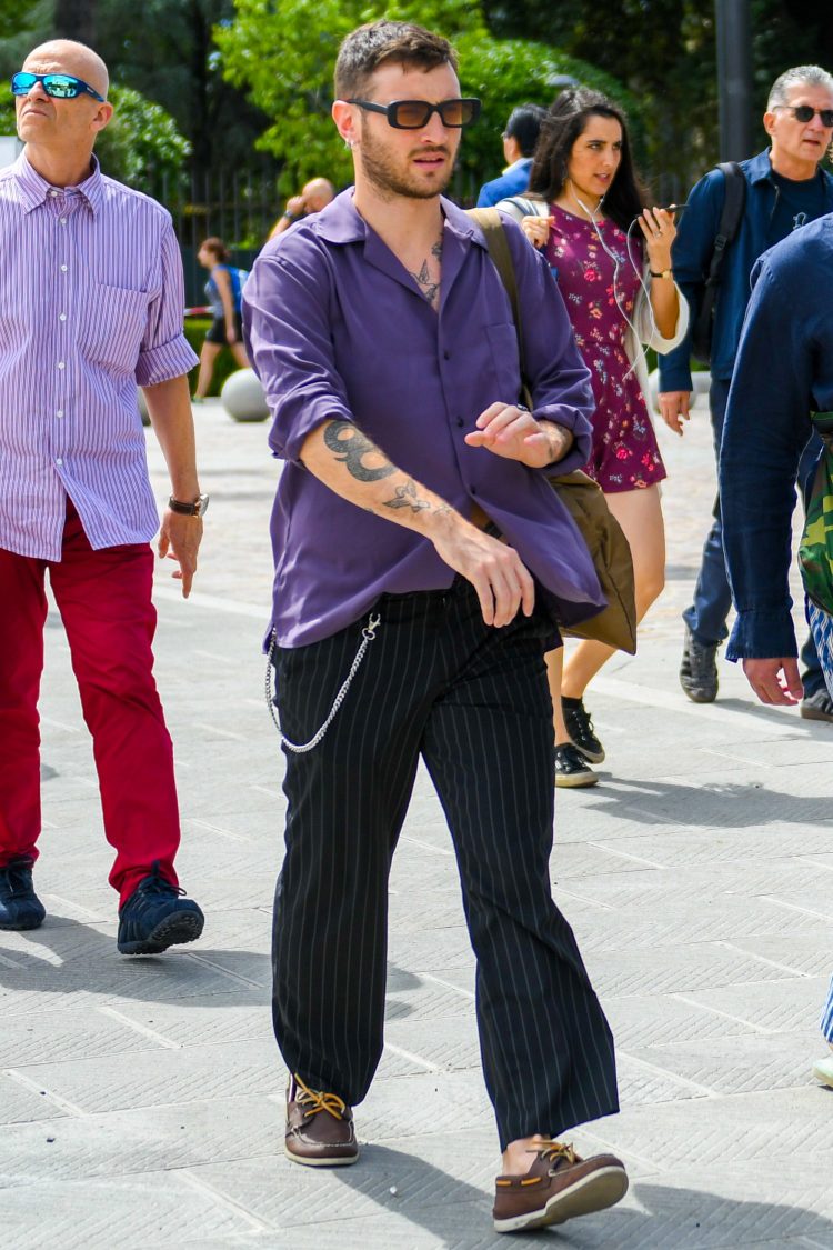 Coordinates an open collar shirt with wide pants for an effortless look