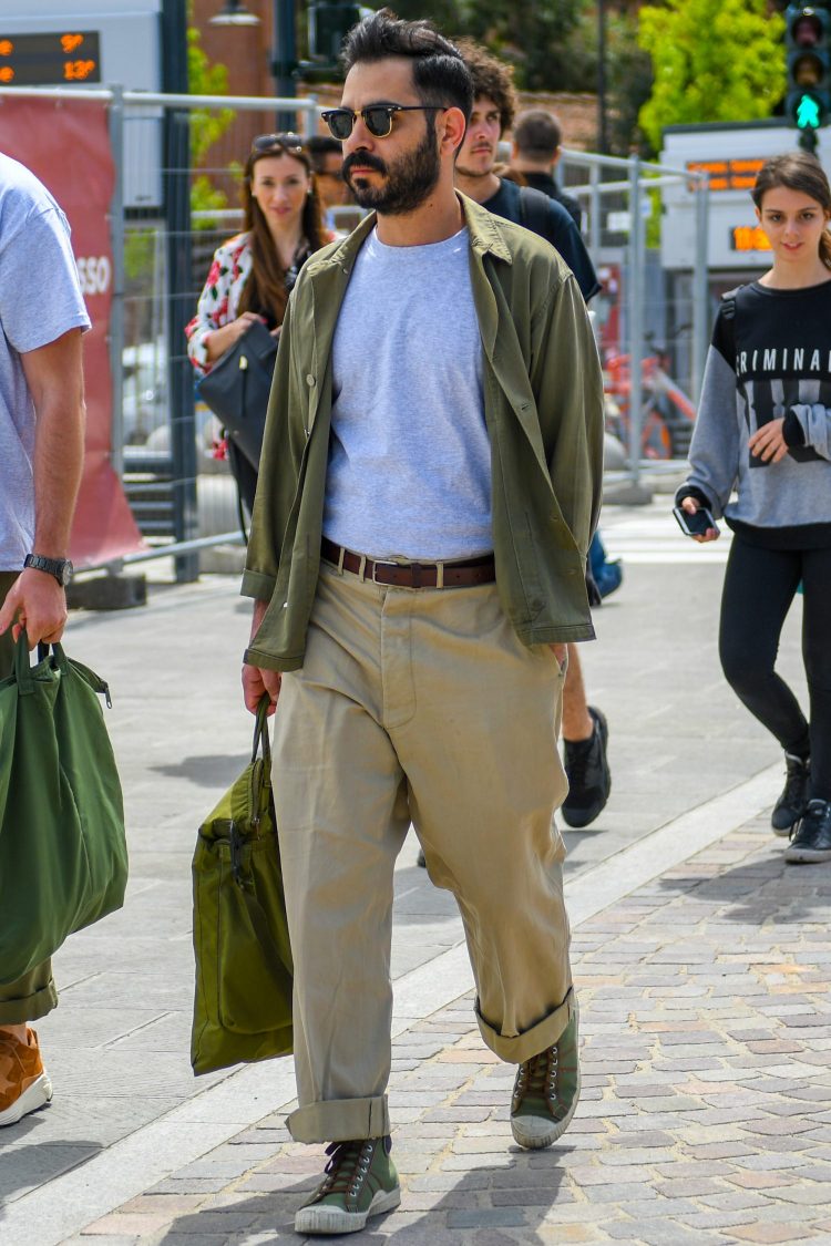 Loose-fit khaki shirt and wide chinos express a relaxed silhouette