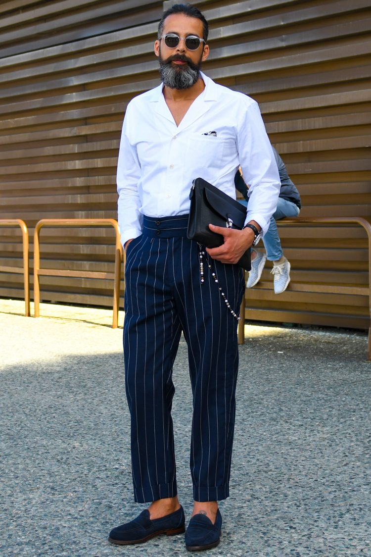 Create an elegant look by tucking an open-collared shirt into dress pants