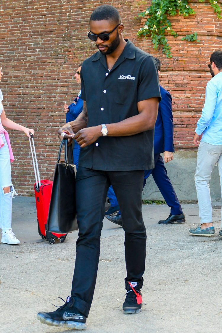 Black coordinate accented with a one-point design on the open-collared shirt