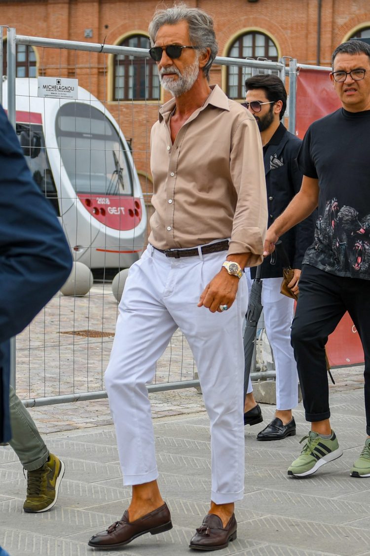 Khaki shirt tucked into white slacks for a classy look