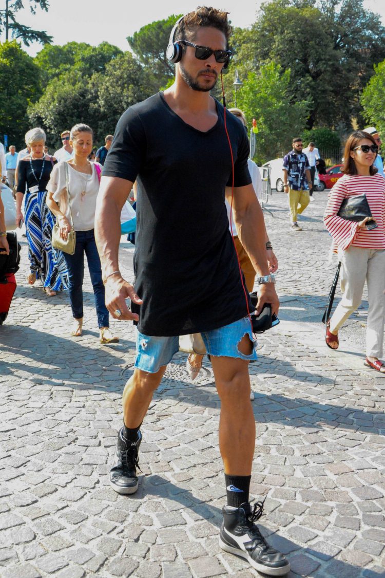 High-cut Diadora black sneakers with a boot-like edge and denim shorts