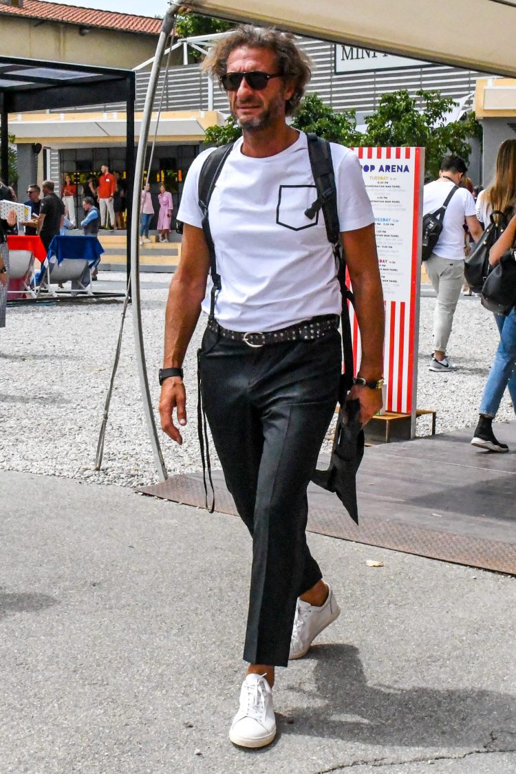 Tuck the T-shirt into the slacks for a classy look.