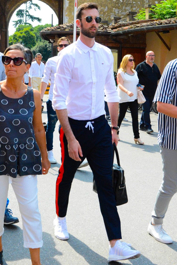 Athleisure style of sideline pants with white shirt and white sneakers for a clean look