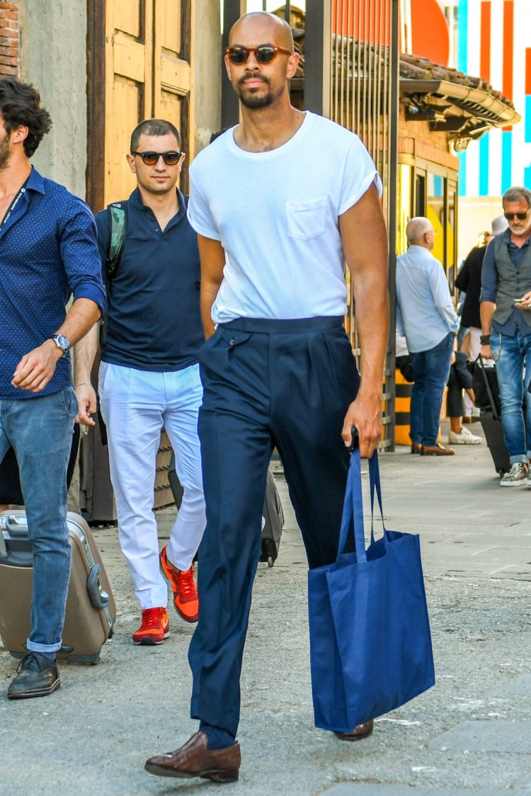 Tuck the T-shirt into the slacks.