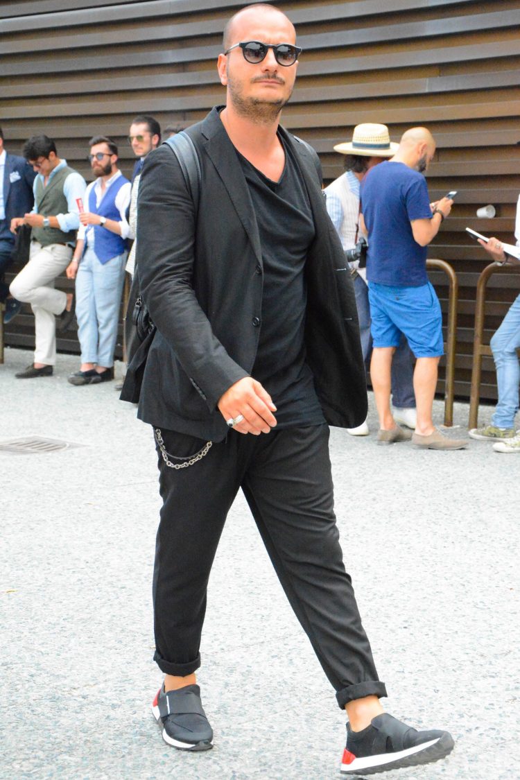 Black suit coordinates with mode sneakers for a stylish look from the feet up.