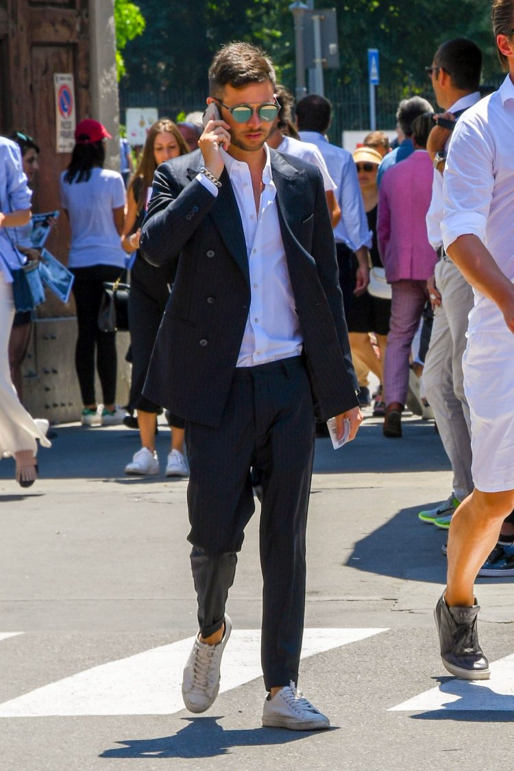 Double-breasted black suit and white shirt encourage a dressier mood.