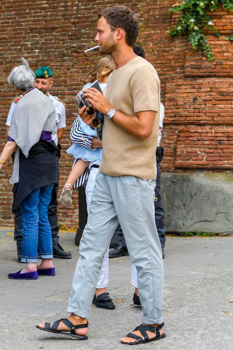 Gray slacks and a knit T-shirt combined with sandals create a dressy look in a rough outfit