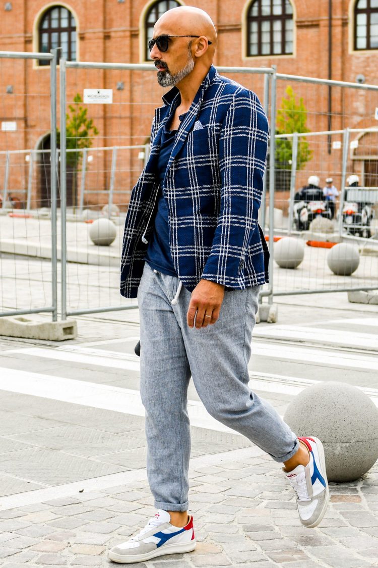 Create an active jackets style with a combination of casual gray pants and sneakers