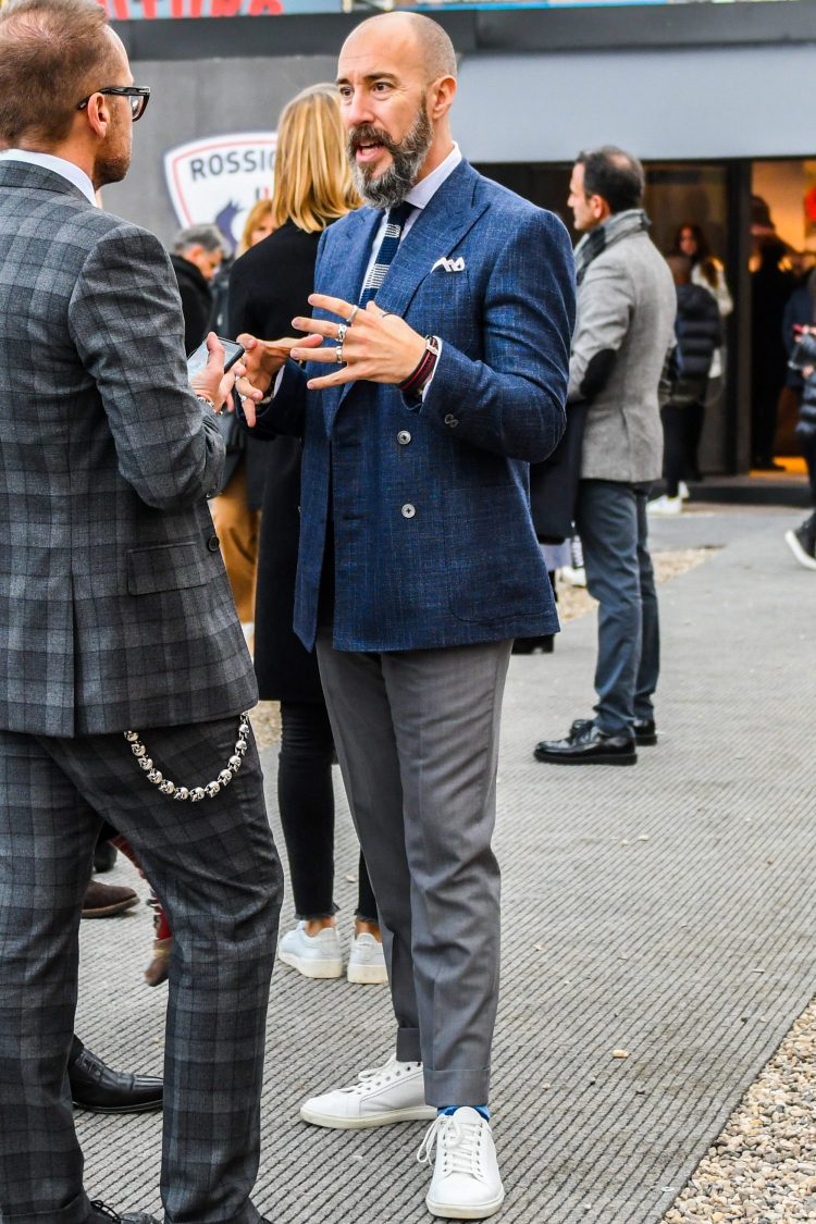 White sneakers add a stylish look to the navy and gray jacketed pants coordinate.
