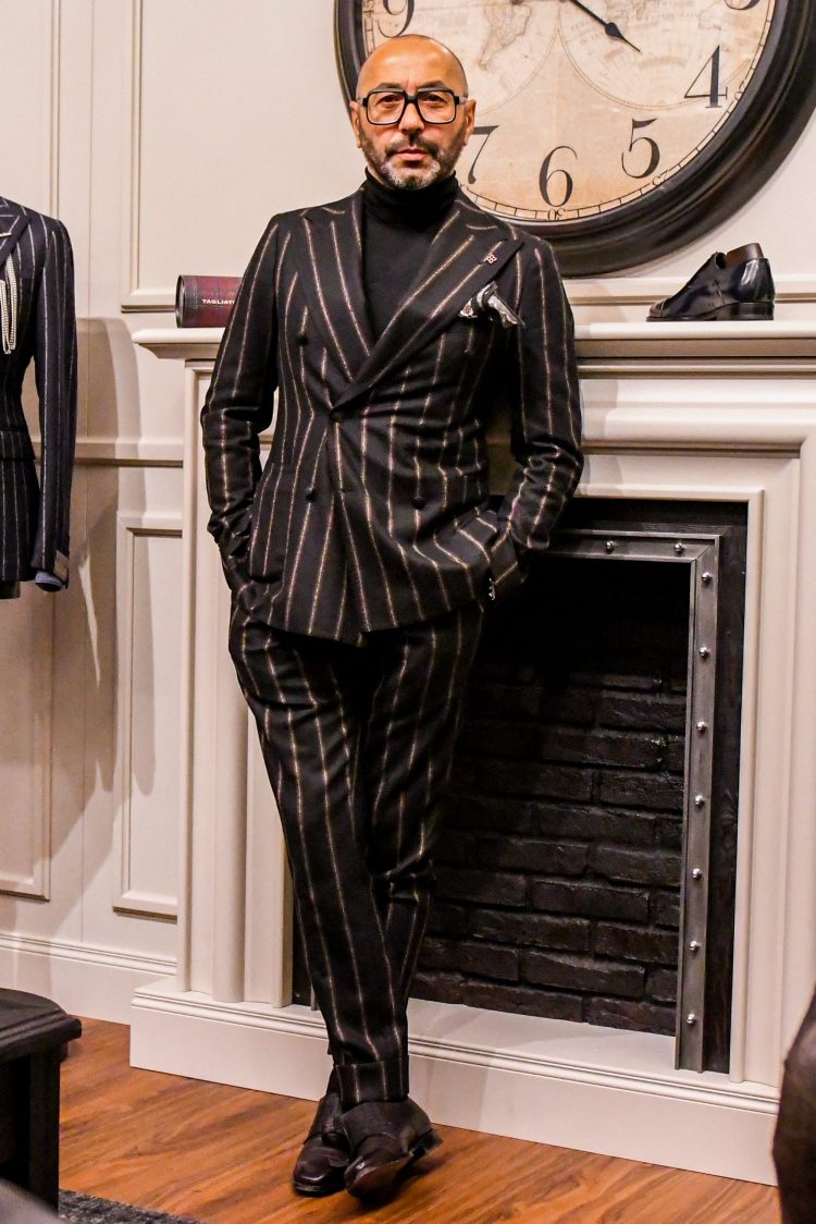 Striped double suit with peaked lapel that accentuates masculinity and glamour, and a black high-neck knit for a chic look