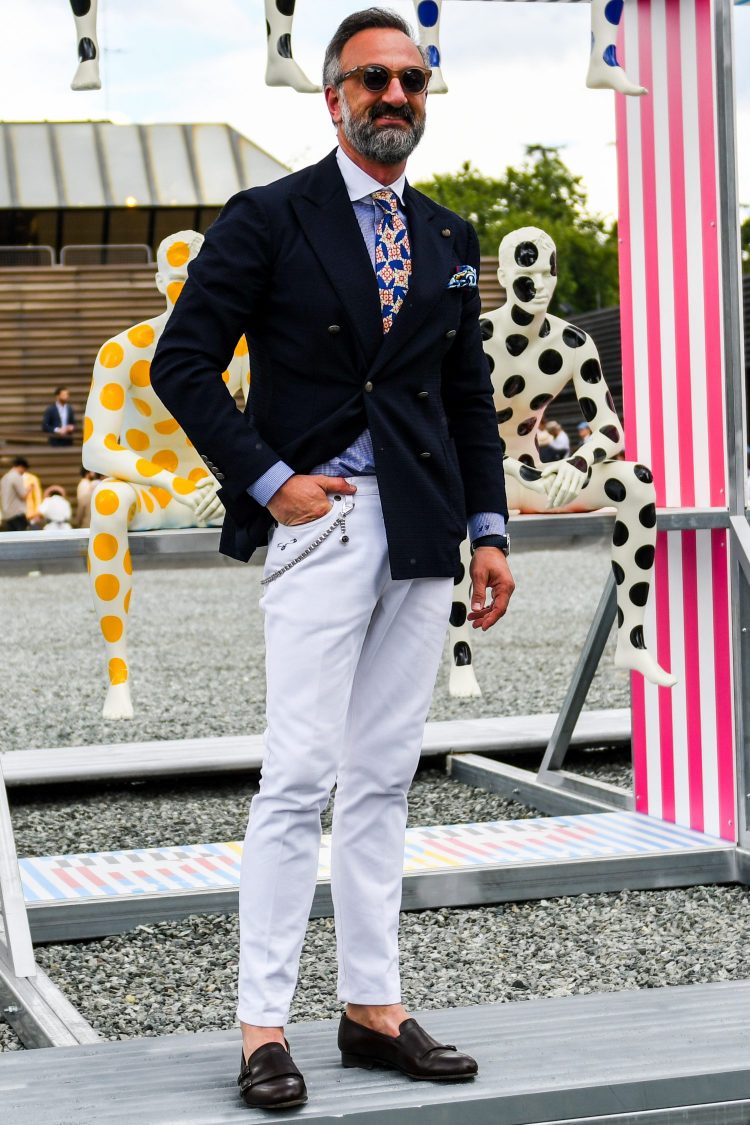 Navy blazer jacket style with a tied-up cleric shirt and white denim for a clean look