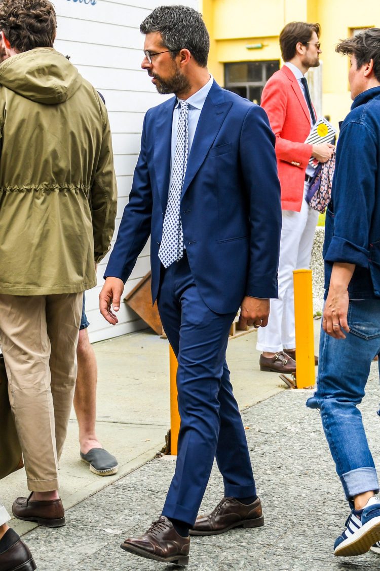Bright tie makes navy suit style more lively