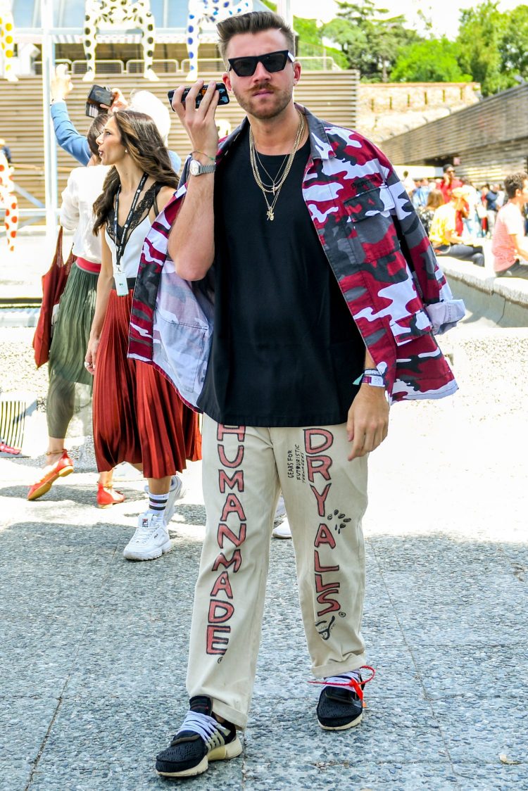 Street coordinate with a quirky camouflage jacket hung over the shoulder for a rough look