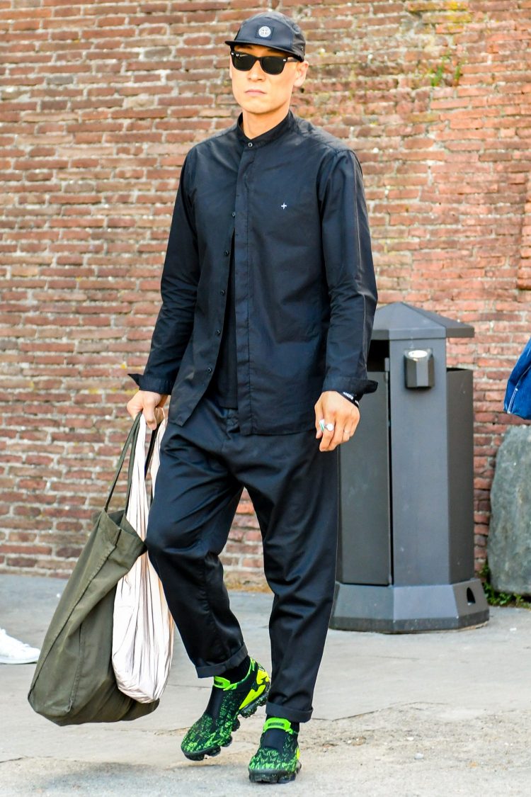 All-black style with a band collar black shirt with an urban, side-swept look.