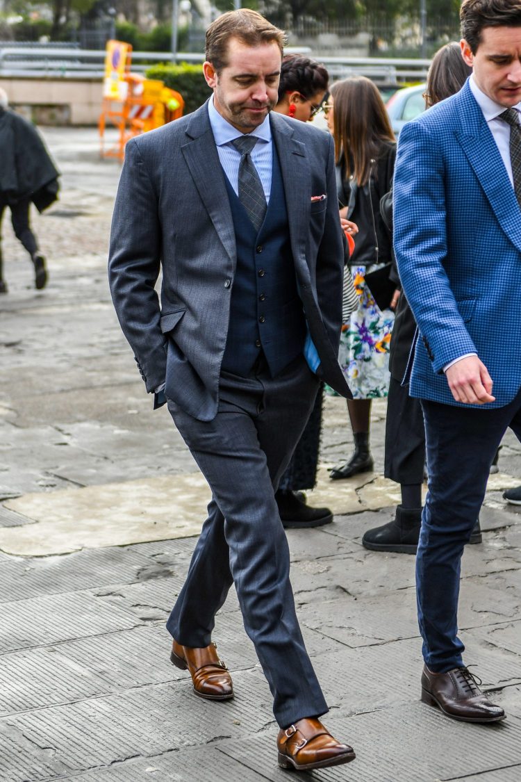 Gray suit and navy jeans coordinate in a chic business style.