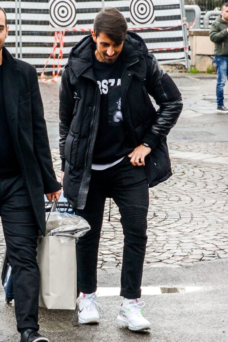 Graphic print black sweatshirt adds a sense of mode to an all-black men's outfit