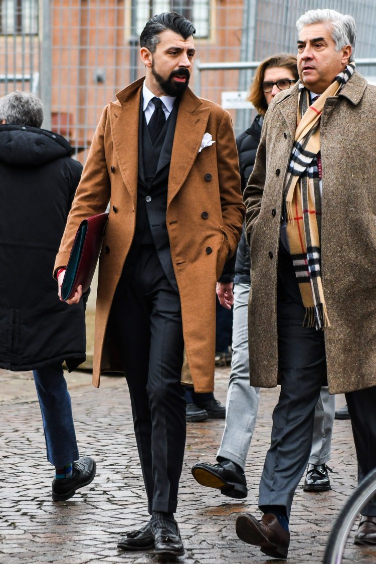 A brown double chester coat adds glamour to a black suit.