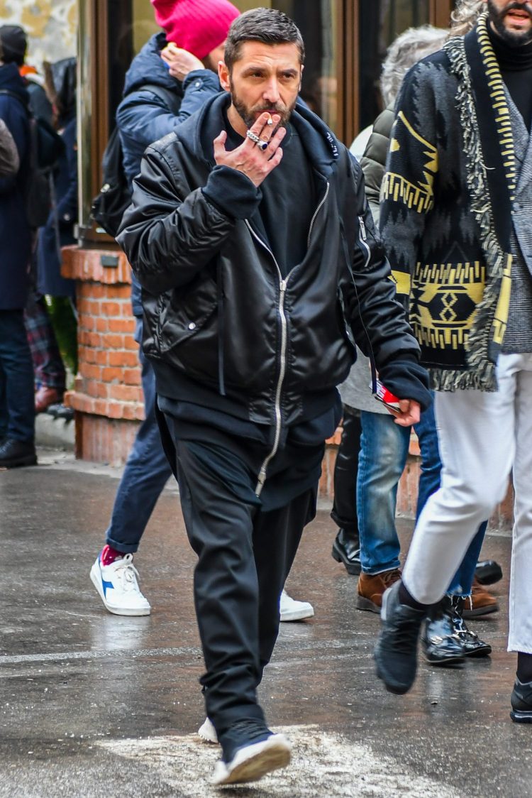 All-black men's street coordinate with black trainers to complement the leading outerwear.