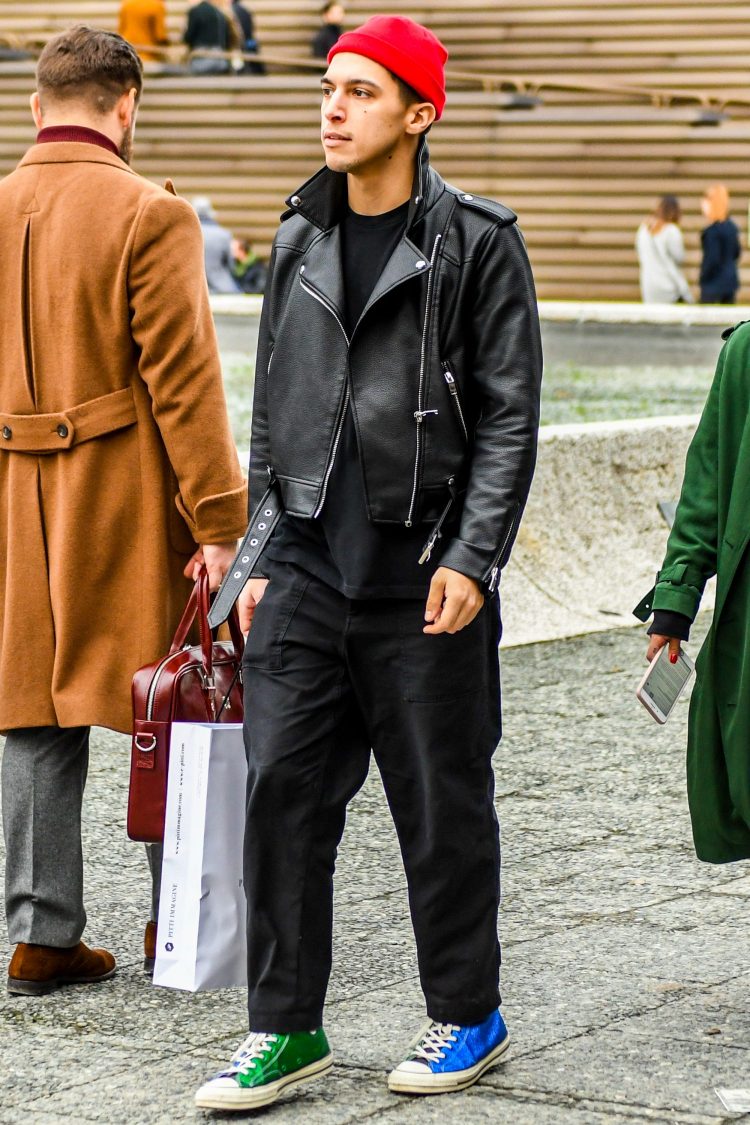 Wide silhouette black pants and a rider's jacket create a moderately loose street style