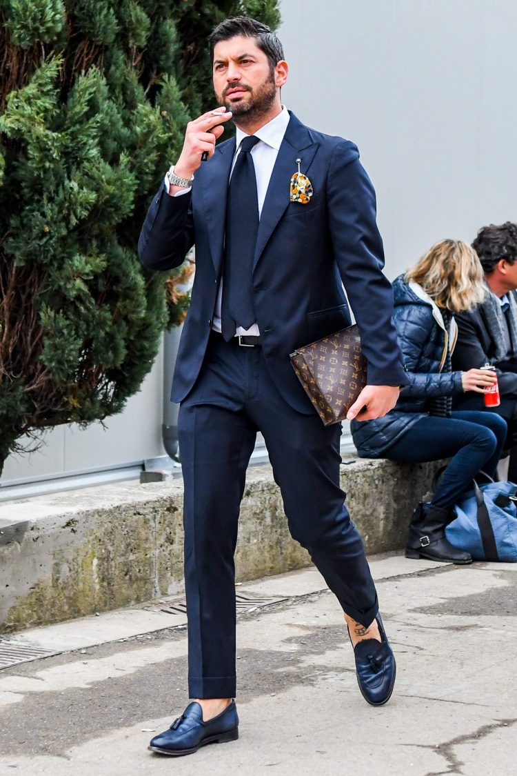 Navy suit and navy tassel loafers that accentuate the dignified atmosphere