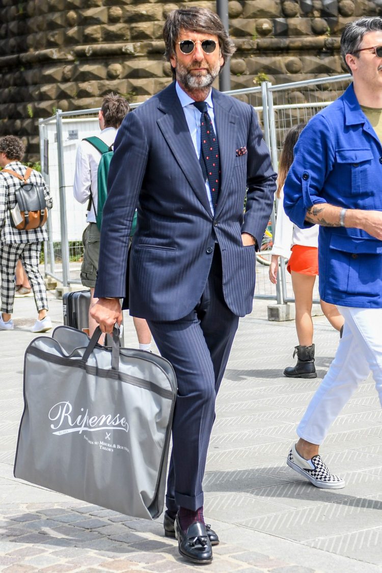 Navy striped suit coordinate accented with a dotted tie and pocket chief