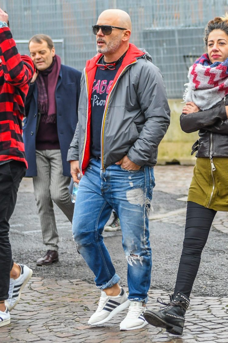Styling of damaged jeans accented with outerwear lining and graphic top