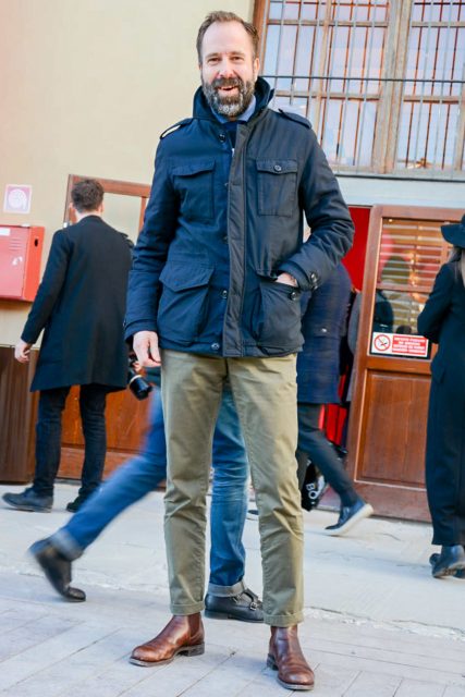 Mixed style with tied-up shirt, military jacket and chinos