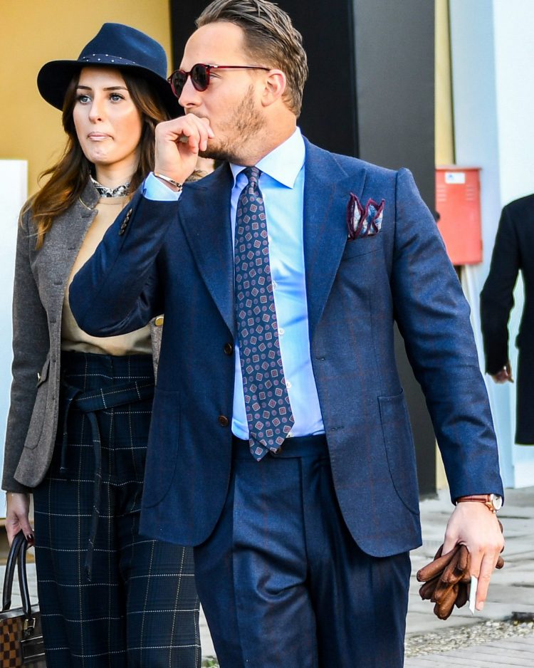 Boston sunglasses with red frames accentuate an authentic suit outfit.