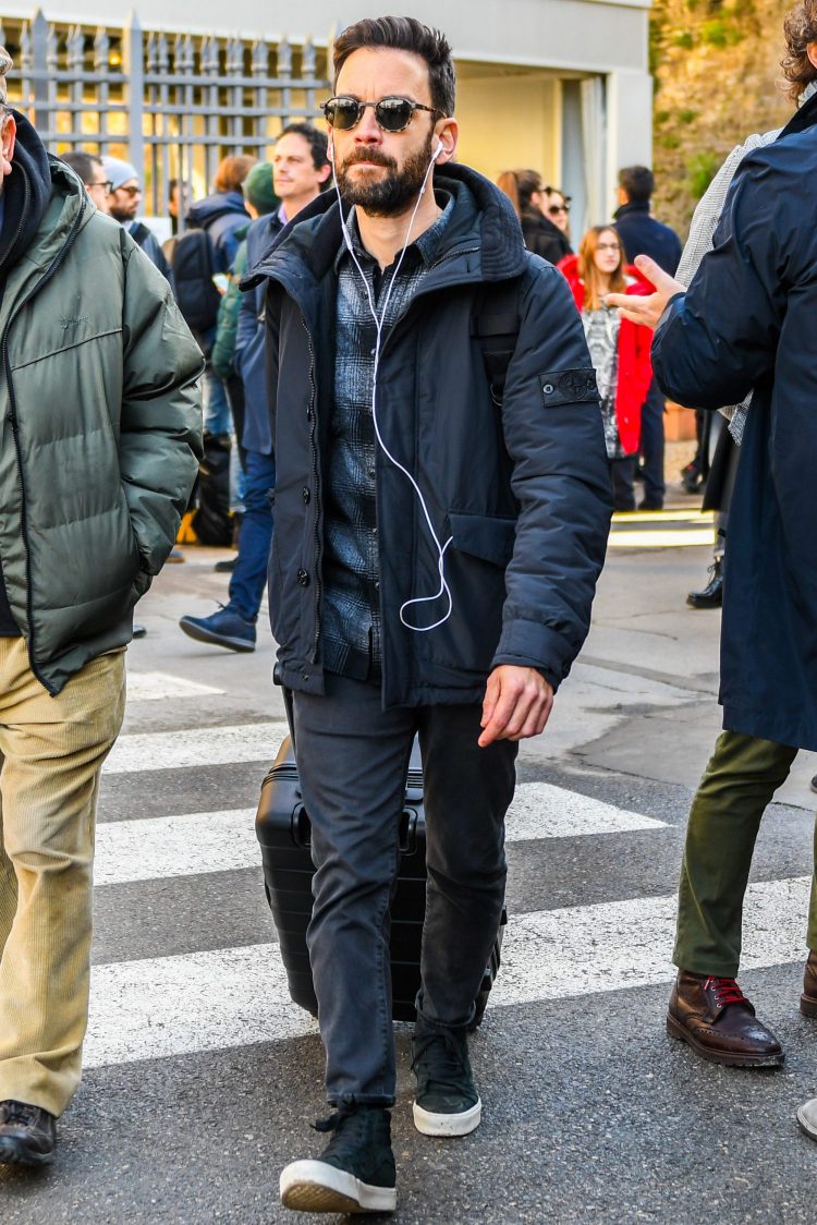 Seasonal branded black puffer jacket coordinate with black high-cut sneakers for a cool look.