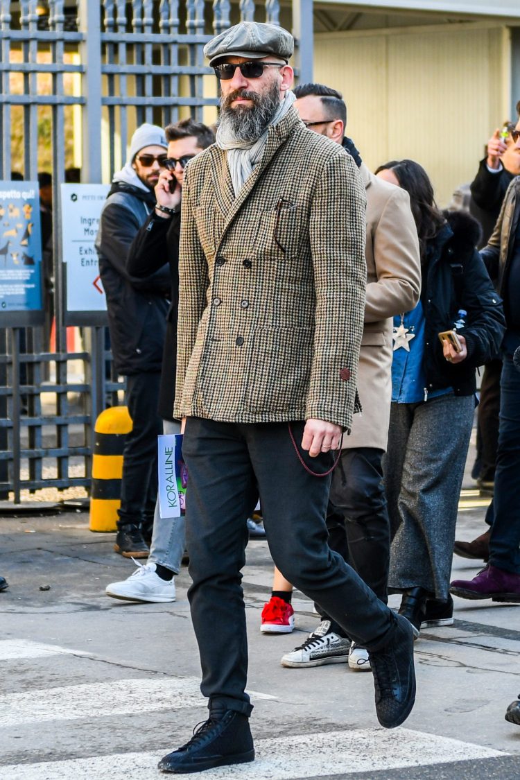 Black high-cut sneakers and black trousers highlight the classic co-ordinated look