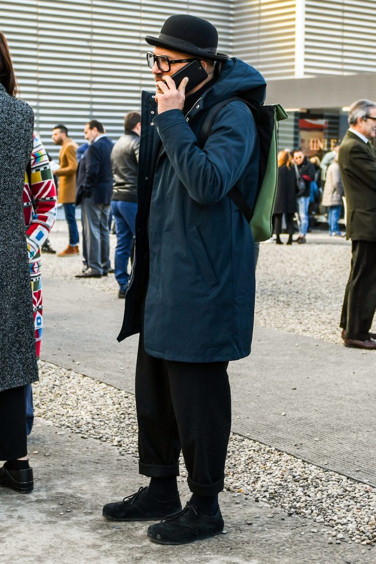 A navy hooded coat adds a crisp look to a matte black coordinate.