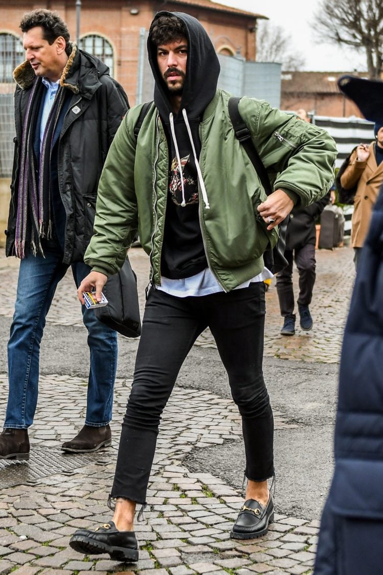 Khaki bomber jacket with a black hoodie and a white T-shirt for a casual look
