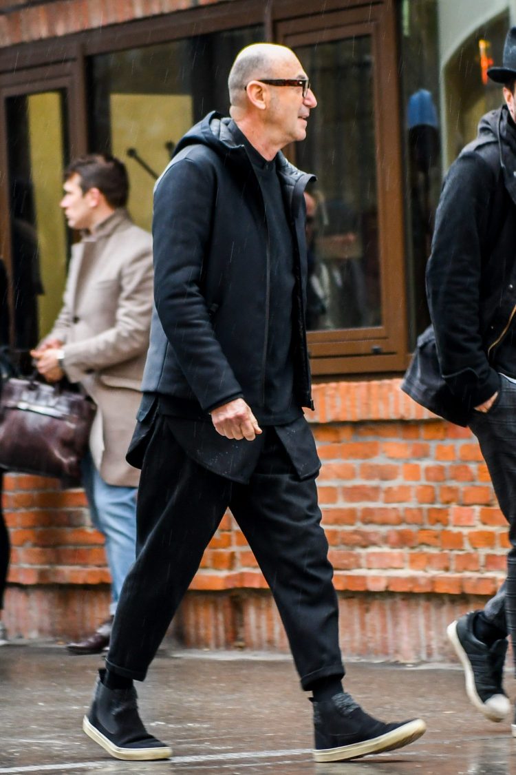 Men's black hooded coat with skillful layering for depth