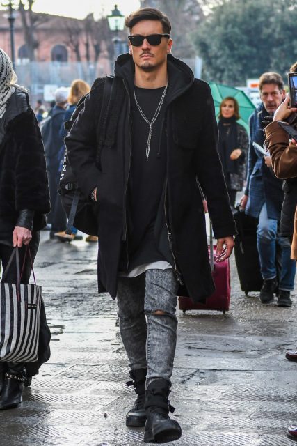 Men's outfit coordinating a big silhouette black sweatshirt parka with black-based items