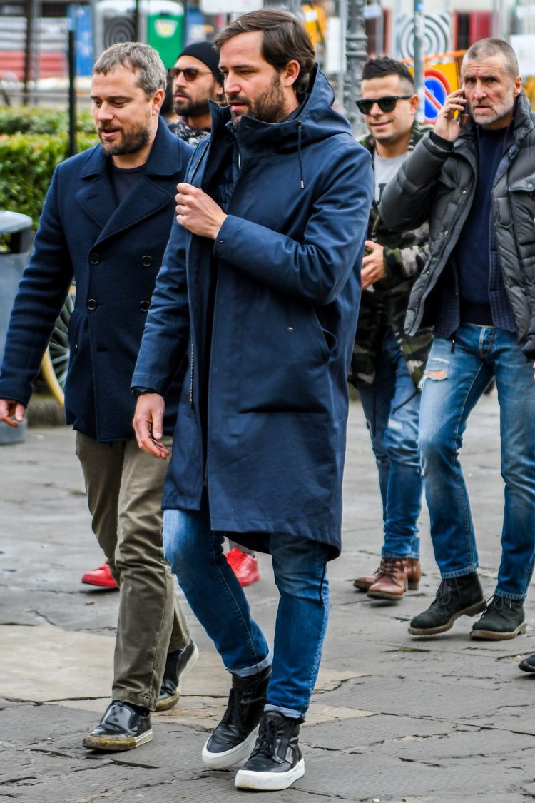 Hooded coat coordinate with combination of blue items pulled together with black sneakers on the feet