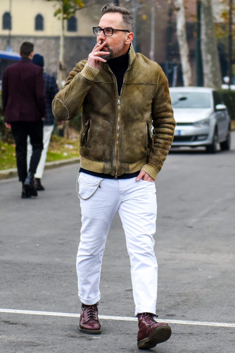 White denim and glossy work boots that accentuate the presence of the leading outerwear
