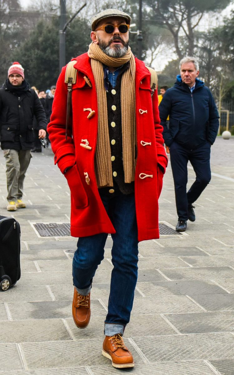 Men's coordinate with dark blue jeans and brown work boots to accentuate the contrast with the red duffle coat.