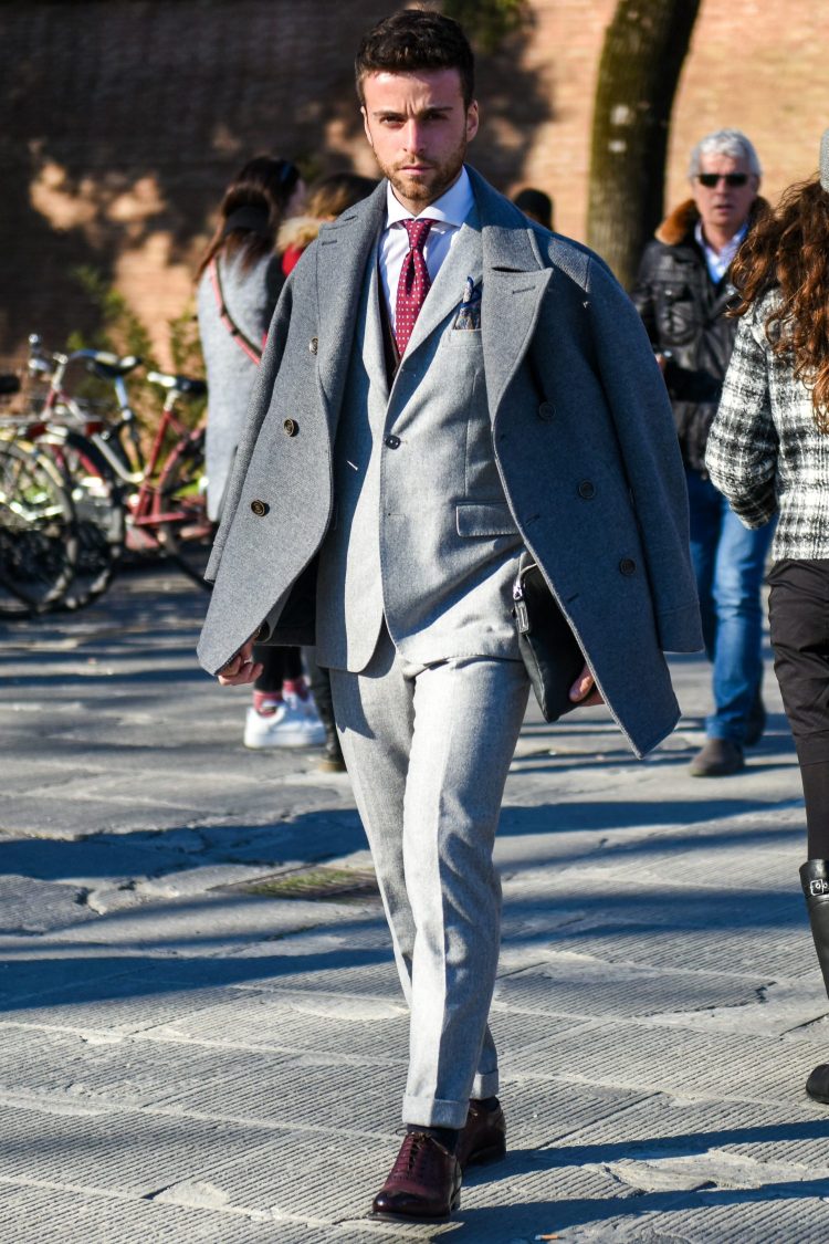 Coordinating gray coat and gray suit with subtle contrasts for increased sophistication