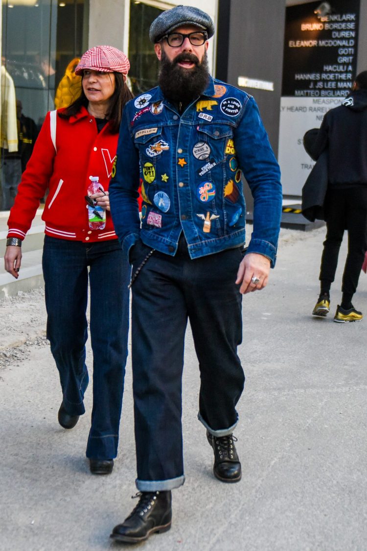 Denim jacket with playful sticky patches and work boots change the image of work style