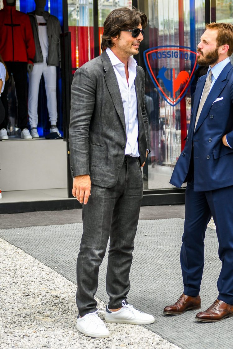 A stylish gray suit with a white shirt and white sneakers to enhance the clean mood.