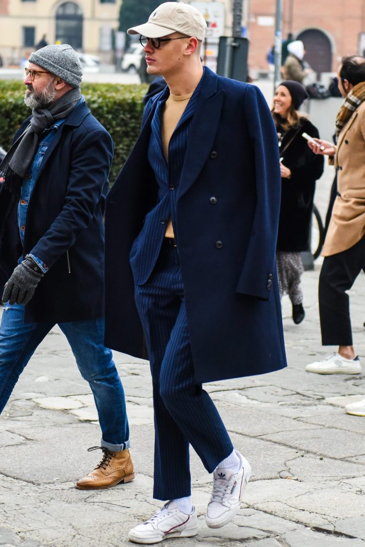 Navy coat and suit coordinate with casual items to create a loose look.