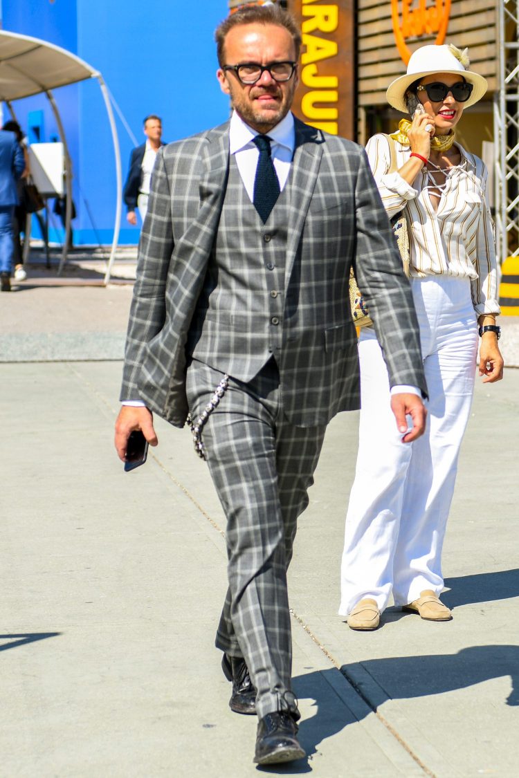 Checked gray suit with silver accessories with skull motifs for an edgy look