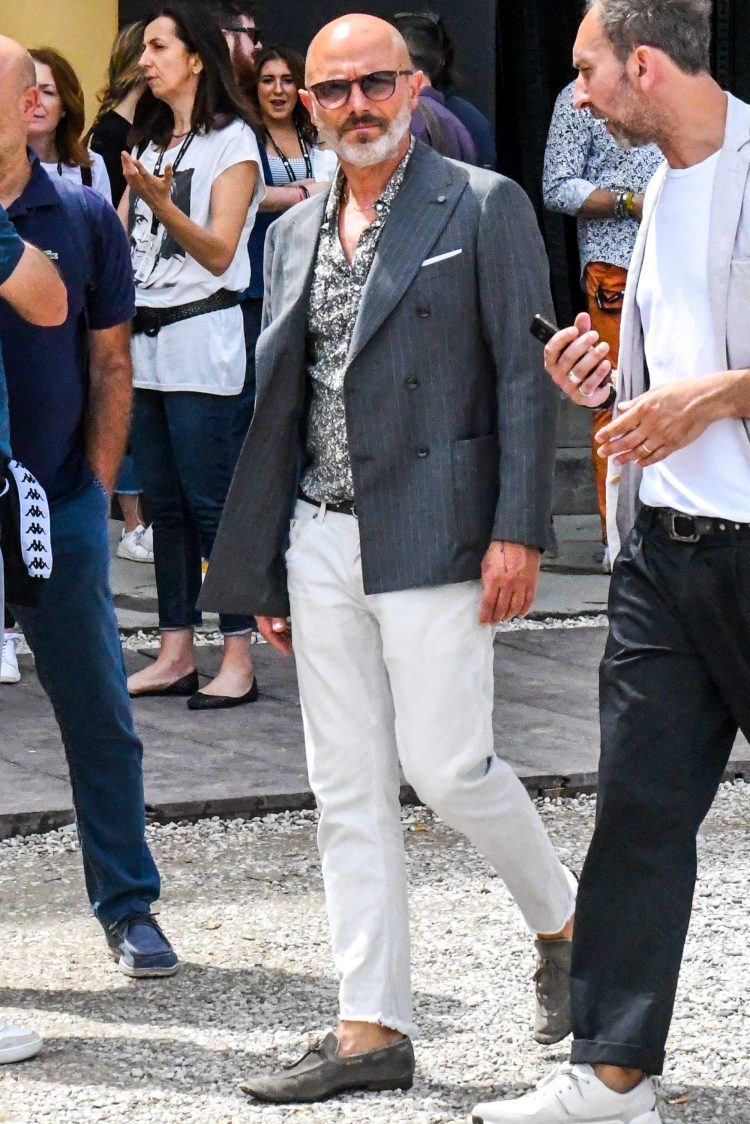 White jeans coordinate with a mildly mischievous patterned shirt