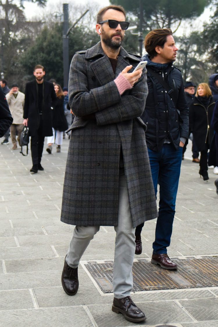 Classic plaid trench coat with gray pants for an urban look