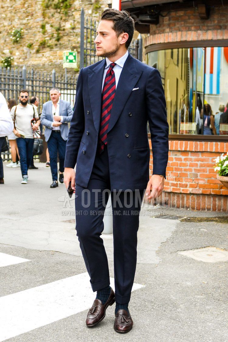 Summer-spring-fall men's coordinate outfit with plain white shirt, plain navy socks, brown coin loafer leather shoes, plain navy suit, and red-navy regimental tie.