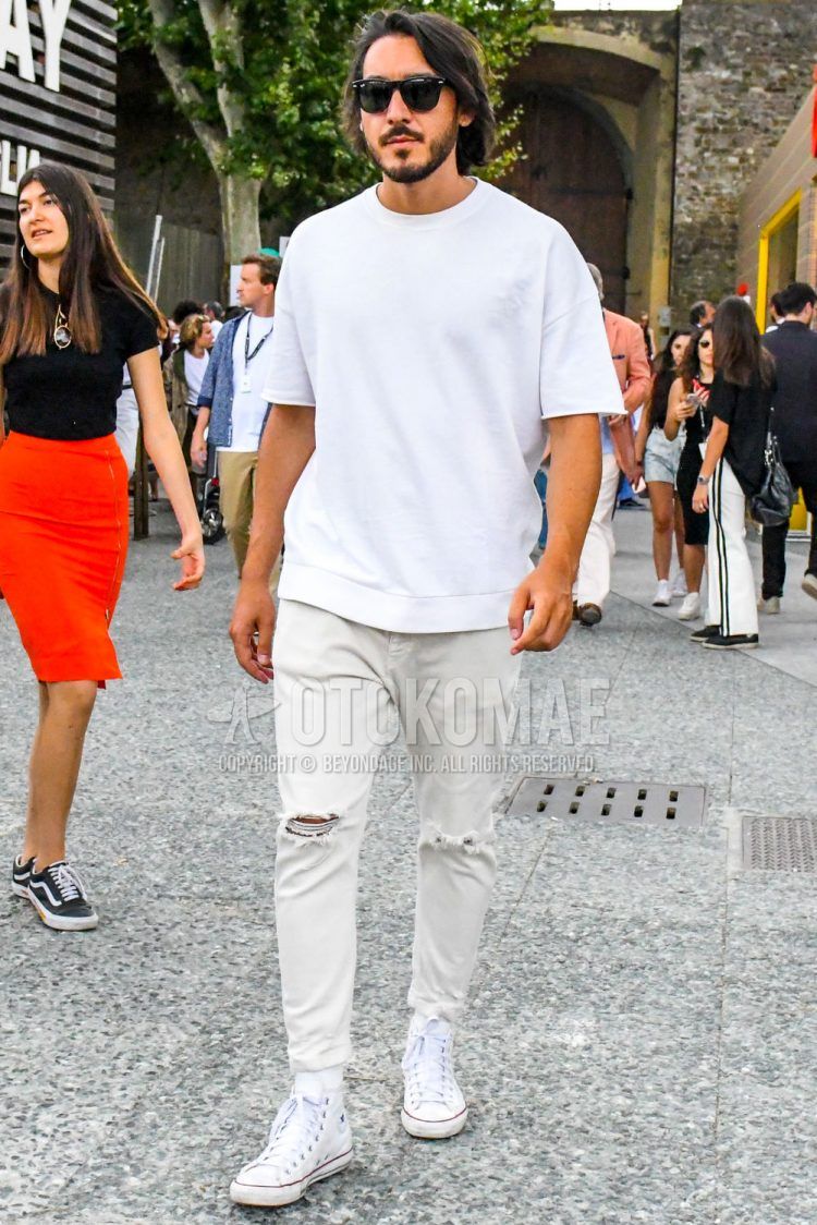 A summer/spring men's coordinate outfit with plain sunglasses, plain white t-shirt, plain white denim/jeans, and white high-cut Converse All Star sneakers.
