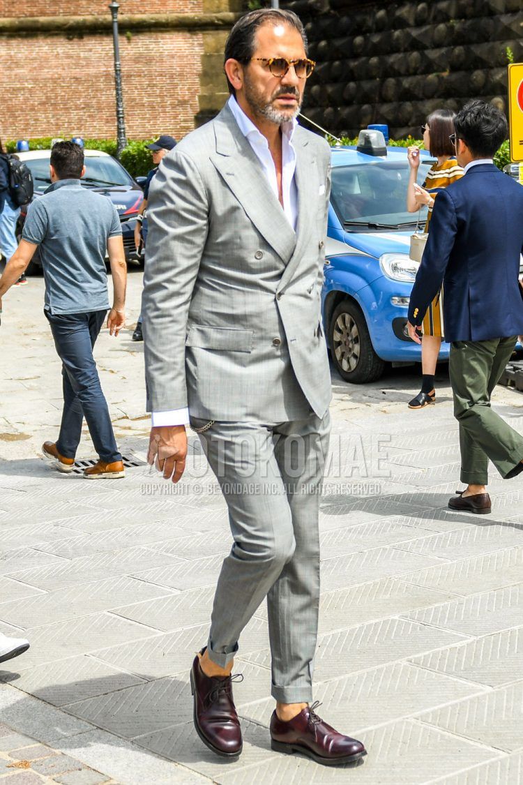 Spring, summer and fall men's coordinate outfit with brown tortoiseshell sunglasses, plain white shirt, brown plain toe leather shoes and plain gray suit.