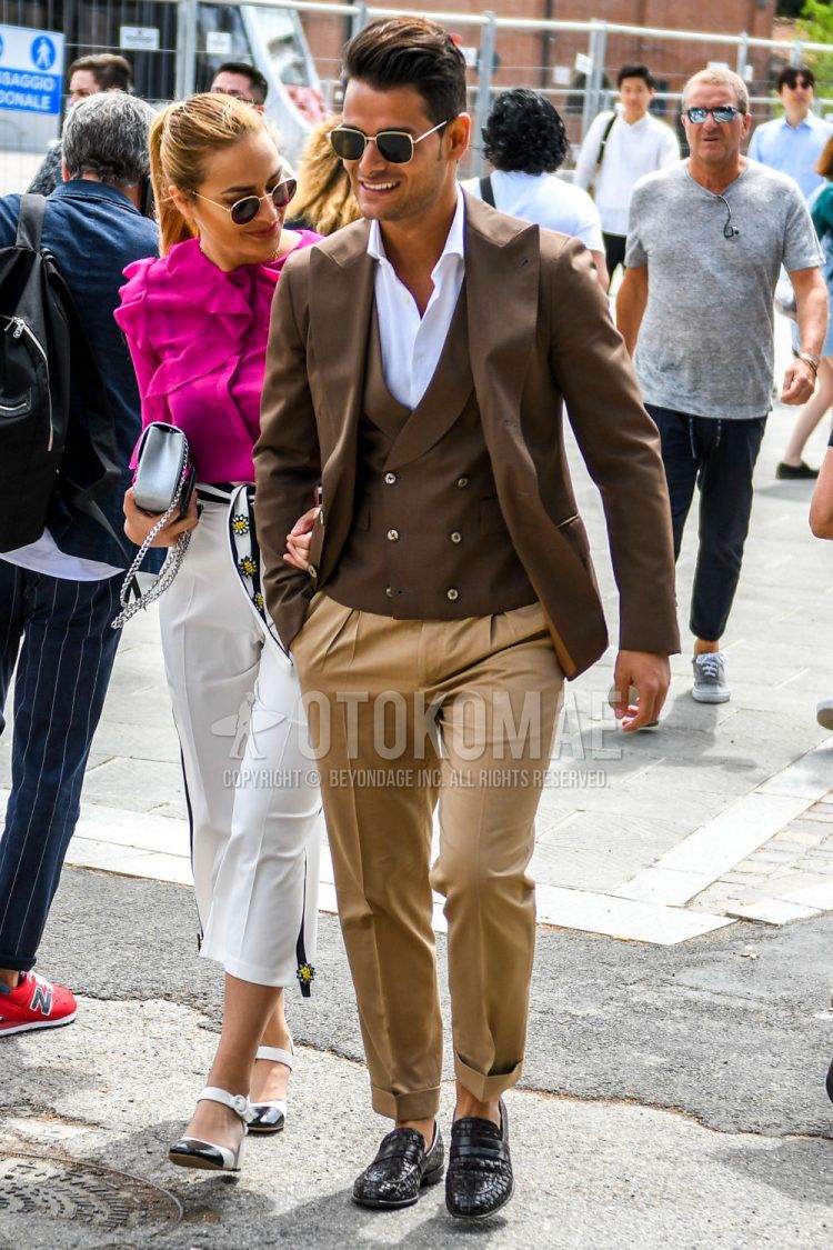 A spring, summer and fall men's coordinate outfit with plain sunglasses, plain brown tailored jacket, plain brown gilet, plain white shirt, plain brown pleated pants, plain brown slacks and black other loafer leather shoes.